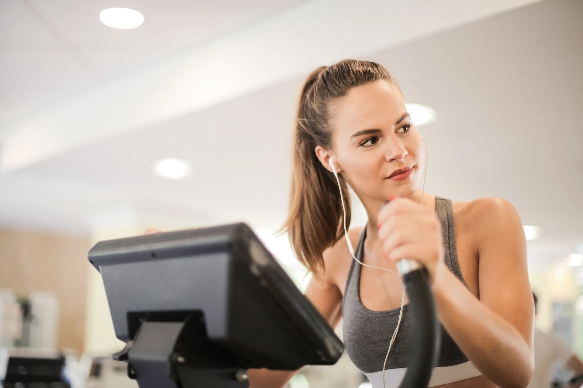 Fitness centre members using the elliptical in the cardio zone