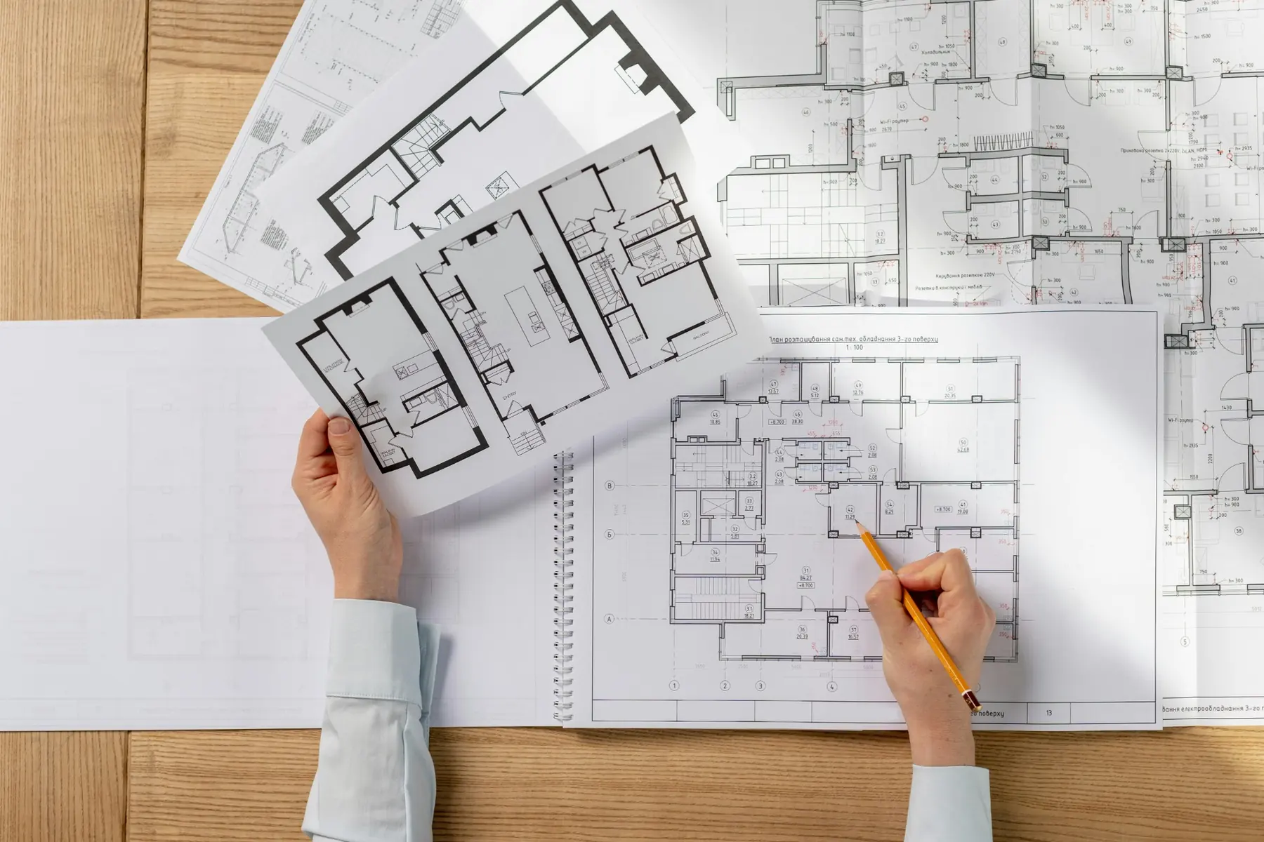 2D custom gym design plans reviewed with a pencil on a table